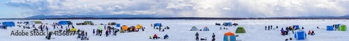 Sakhalin, Russia - 02.21.2021: Competition of fishermen in winter on the Naiba river.Panorama.