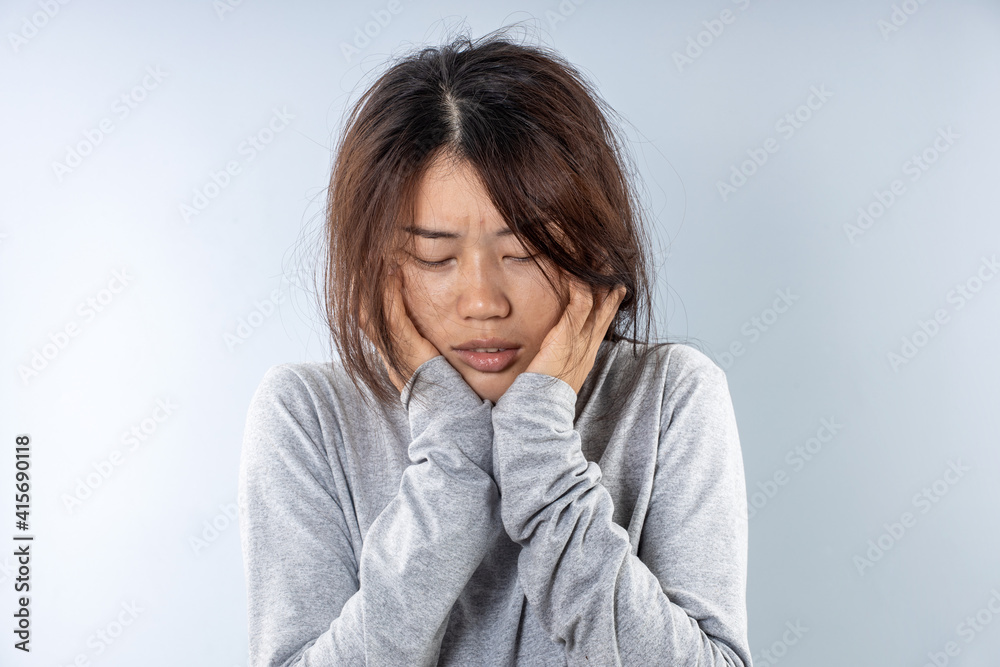 A woman in Asia is suffering from a toothache A woman in Asia is suffering from a toothache