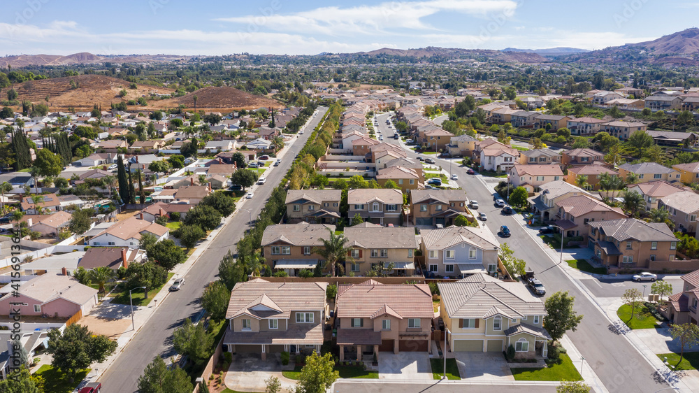 Daytime aerial view of a high density suburban neighborhood in Riverside, California, USA.