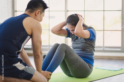Adult asian man and woman family wearing sport outfit do exercise workout for healthy self care at home