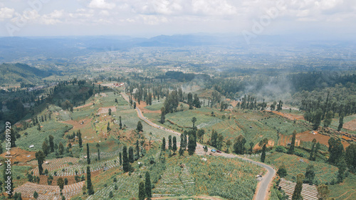 Aerial view of mountain valley with green scenery in Sindoro vulcano