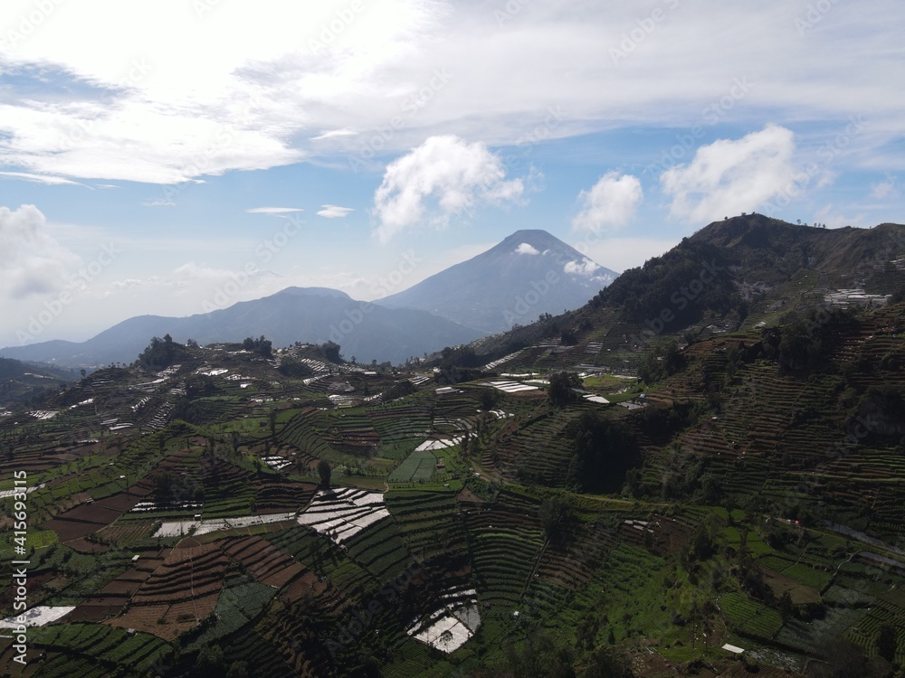 Fototapeta premium Aerial view of Dieng village at Wonosobo with mountain around it
