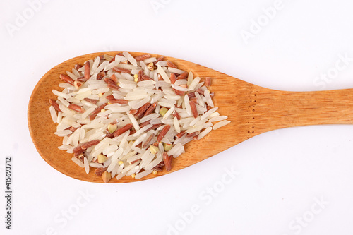 Mixed low glycaemic index healthy rice grain basmati millet buckwheat red rice in wooden spoon on white background top view photo