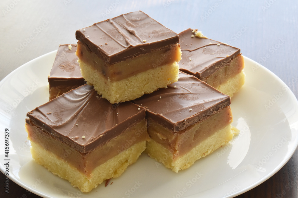 Millionaire's shortbread, caramel shortcake, or millionaire's slice. Copy space is on the right side. Millionaire's shortbread, caramel shortcake, or millionaire's slice. Copy space is on the right side.