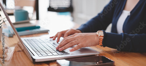 Cropped shot of businesswoman working,typing on tablet computer. Selective focus,Soft focus.