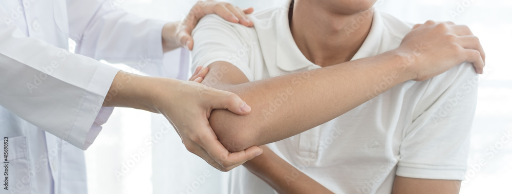 Female physiotherapists provide assistance to male patients with elbow injuries examine patients in rehabilitation centers. Rehabilitation physiotherapy concept