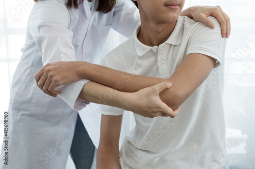 Female physiotherapists provide assistance to male patients with elbow injuries examine patients in rehabilitation centers. Rehabilitation physiotherapy concept