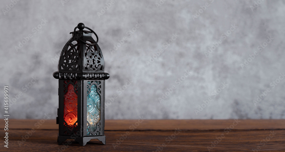 On table top image of decorations Ramadan Kareem holiday background.Close up Arabic lantern metal on brown wooden.Lighing sign for Muslim or Isiam religion.copy space for creative design. On table top image of decorations Ramadan Kareem holiday background.Close up Arabic lantern metal on brown wooden.Lighing sign for Muslim or Isiam religion.copy space for creative design.