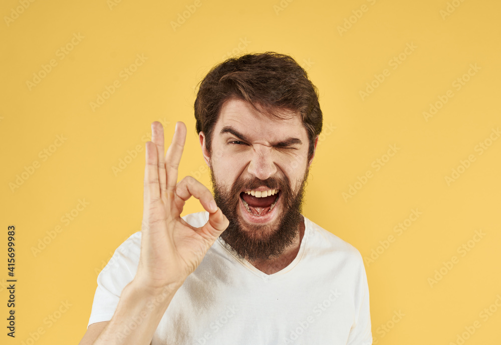 man in a t-shirt positive gesture with his hands white t-shirt bushy beard man in a t-shirt positive gesture with his hands white t-shirt bushy beard