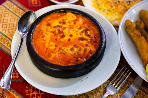 Turkish cuisine, baked shrimps with tomato sauce and melted cheese