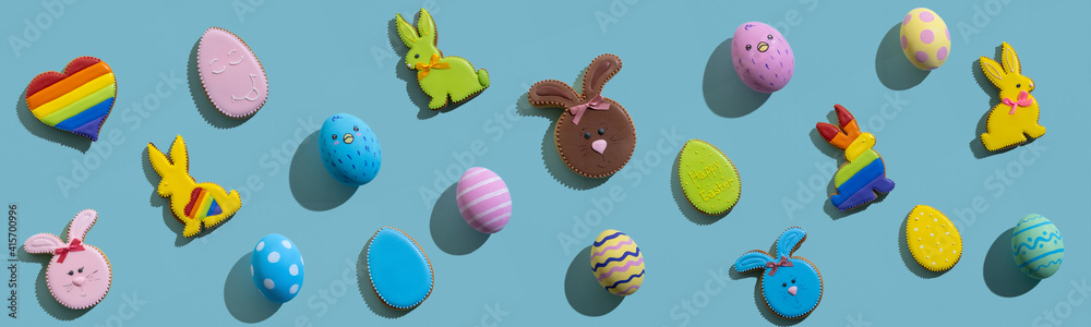 Easter background. Festive pattern. Holiday decoration. Lgbtqia design. Colorful gingerbread biscuit bunny rainbow heart painted chicken egg cute composition isolated on blue. Easter background. Festive pattern. Holiday decoration. Lgbtqia design. Colorful gingerbread biscuit bunny rainbow heart painted chicken egg cute composition isolated on blue.