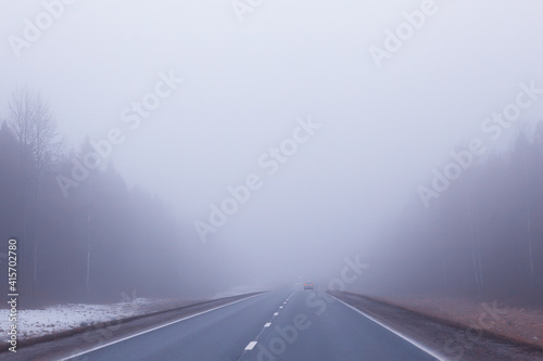 road in fog concept, mist in october halloween landscape, highway