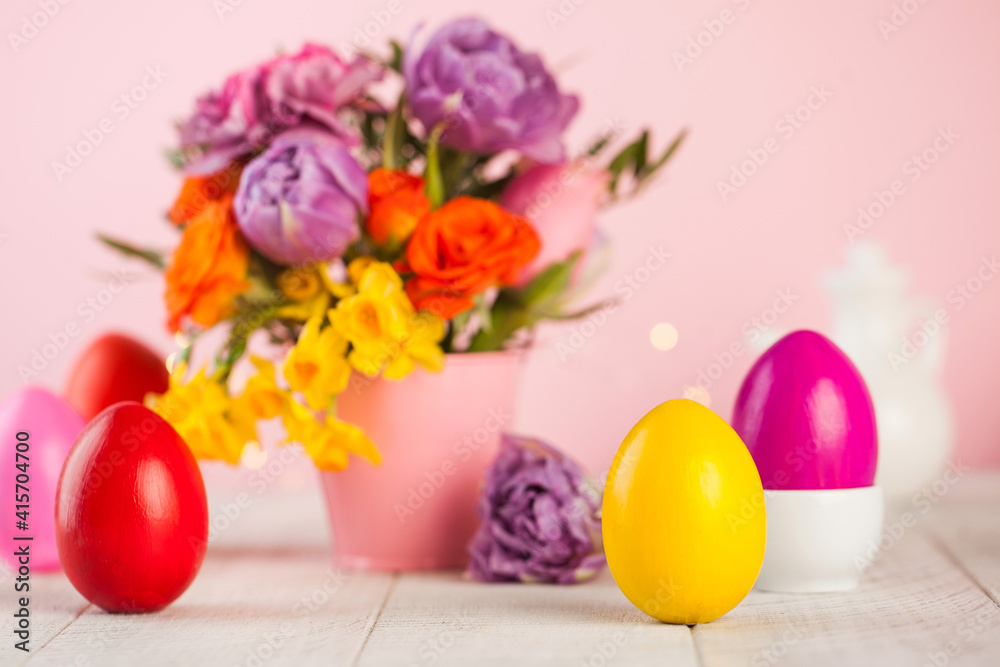 Easter colorful eggs on the background of spring flowers. Bright Easter concept. Copy space. Easter colorful eggs on the background of spring flowers. Bright Easter concept. Copy space.