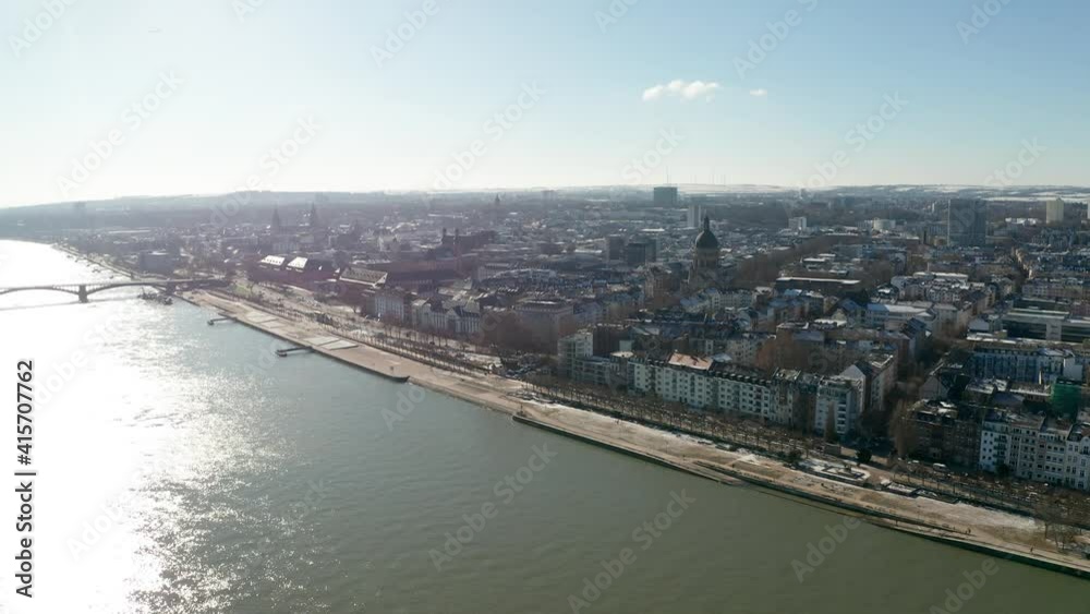 High Drone flight over a snowy Mainz the City of Biontech on a sunny Winter day showing flood of the Rhine river and blue sky High Drone flight over a snowy Mainz the City of Biontech on a sunny Winter day showing flood of the Rhine river and blue sky