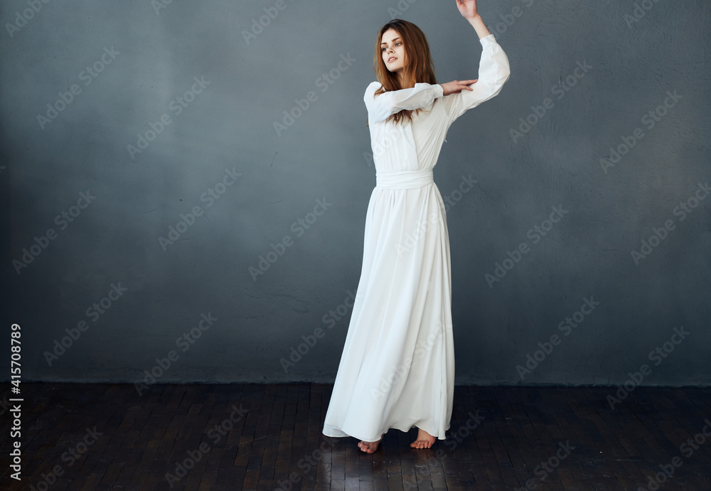 Fototapeta premium Woman in white dress on gray background red hair model romance 
