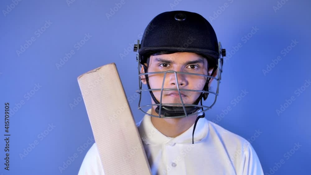 Indian cricket batsman with helmet bat and gloves in hands looking at