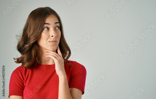 pretty woman holding hair red t-shirt emotions isolated background