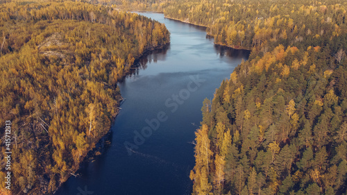 Aerial drone view on Yastrebinoe lake. Beautiful season landscape with a lake isthmus and larch trees. Russia, Karelia.