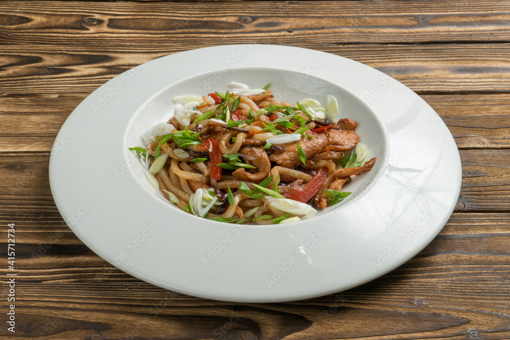 Chinese noodles with chicken fried bell pepper and onion in teriyaki sauce. Chinese noodles with chicken fried bell pepper and onion in teriyaki sauce.