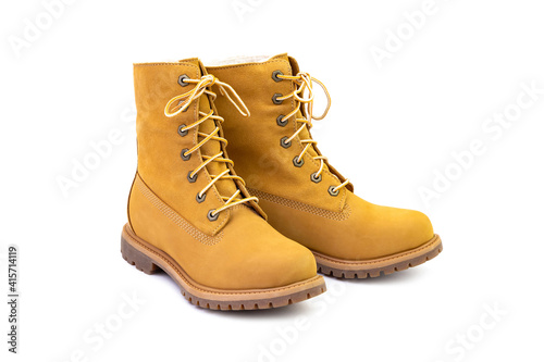 Pair of short yellow leather boots isolated on white background. Fashion and shopping concept