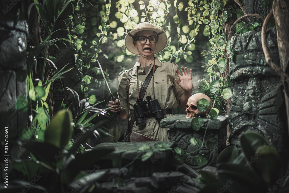 Scared explorer finding a skull in the jungle