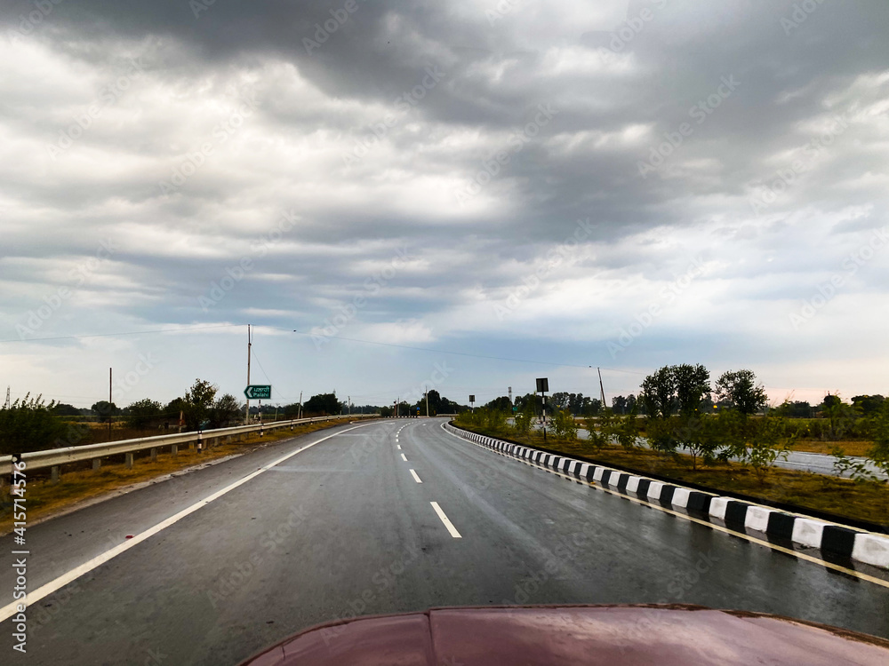 Fototapeta premium View of empty roads and cloudy sky while driving on a highway in the city