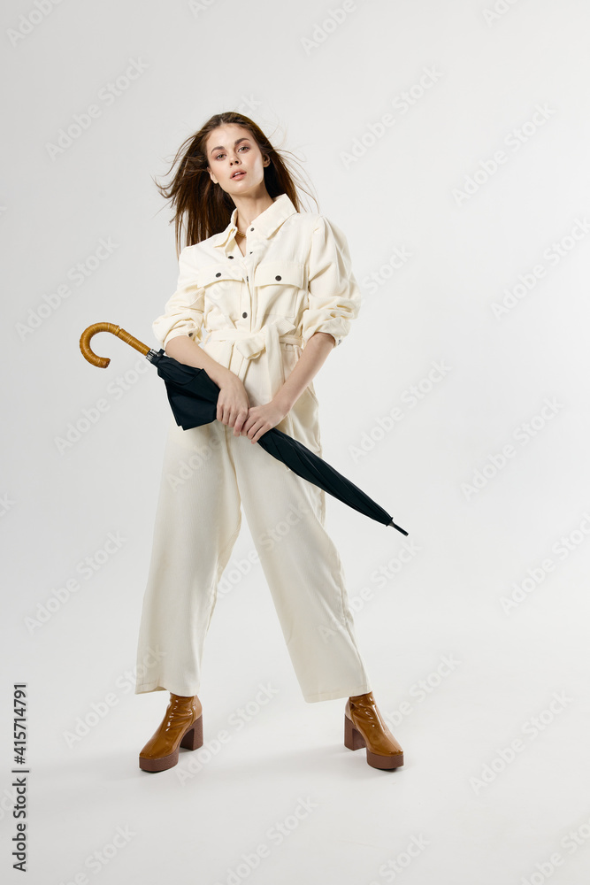 pretty woman holding umbrella jumpsuit fashion boots full length model pretty woman holding umbrella jumpsuit fashion boots full length model