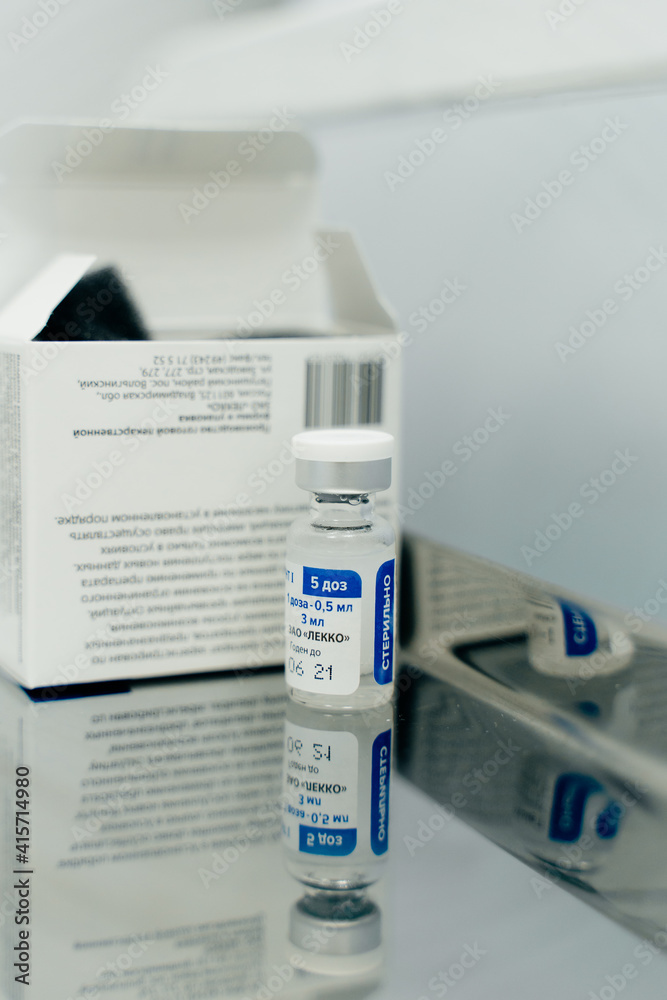 Cheboksary, Chuvashia, Russia, 01/23/2021: Beginning of mass vaccination of people against coronavirus COVID-19 in Russia, ampoule with Sputnik V vaccine. Cheboksary, Chuvashia, Russia, 01/23/2021: Beginning of mass vaccination of people against coronavirus COVID-19 in Russia, ampoule with Sputnik V vaccine.