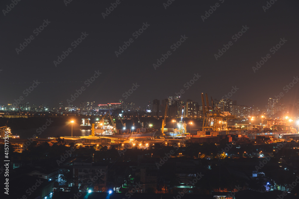 Aerial panoramic cityscape view of Ho Chi Minh city and the River Saigon, Vietnam with beautiful lights at night. Financial and business centers in developed Vietnam