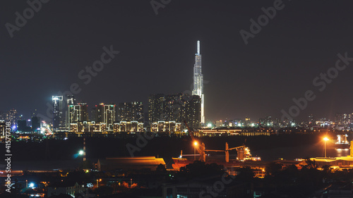 Aerial panoramic cityscape view of Ho Chi Minh city and the River Saigon  Vietnam with beautiful lights at night. Financial and business centers in developed Vietnam