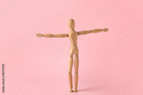 Wooden mannequin on color b...