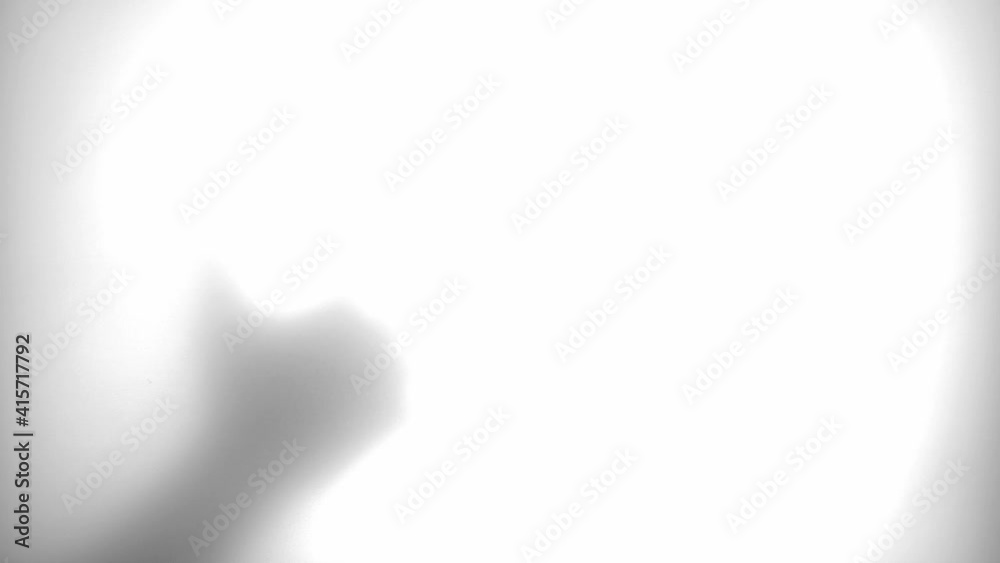 Male Hand Behind Translucent Glass Touching Scratching and Stroking the Surface