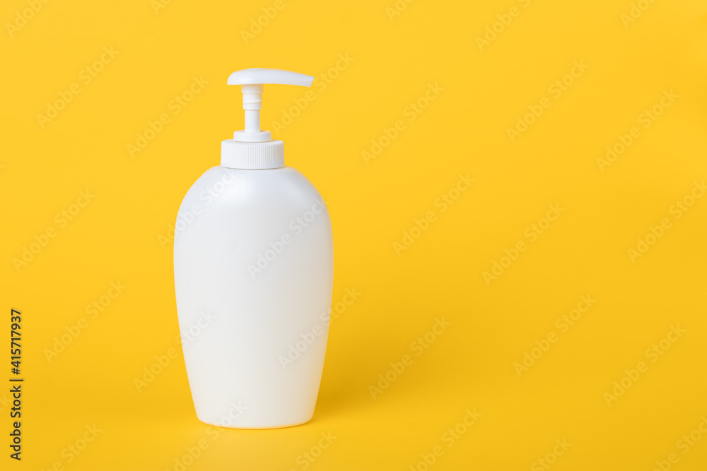 Bottle of liquid soap, white plastic flacon with dispenser on a yellow background. Copy space, empty place for text. Pump lotion. Shower gel for body. Personal hygiene concept. Bottle of liquid soap, white plastic flacon with dispenser on a yellow background. Copy space, empty place for text. Pump lotion. Shower gel for body. Personal hygiene concept.