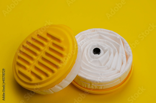 New replacement filters for Industrial respirator on yellow background.