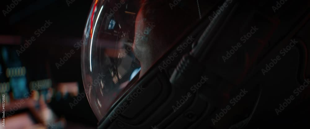 Portrait of Caucasian male astronaut inside spaceship cockpit. Sci-fi space exploration concept. Mars mission. Shot with 2x Anamorphic lens
