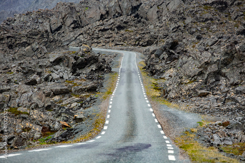 Narrow and empty road by Norwegian coast at Varanger peninsula, Norway photo