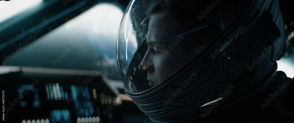 Portrait of Caucasian male astronaut inside spaceship cockpit. Sci-fi space exploration concept. Shot with 2x Anamorphic lens