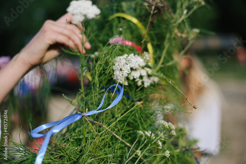 Bunch of green grass wrapped in colored ribbons to celebrate the Slavic solstice photo