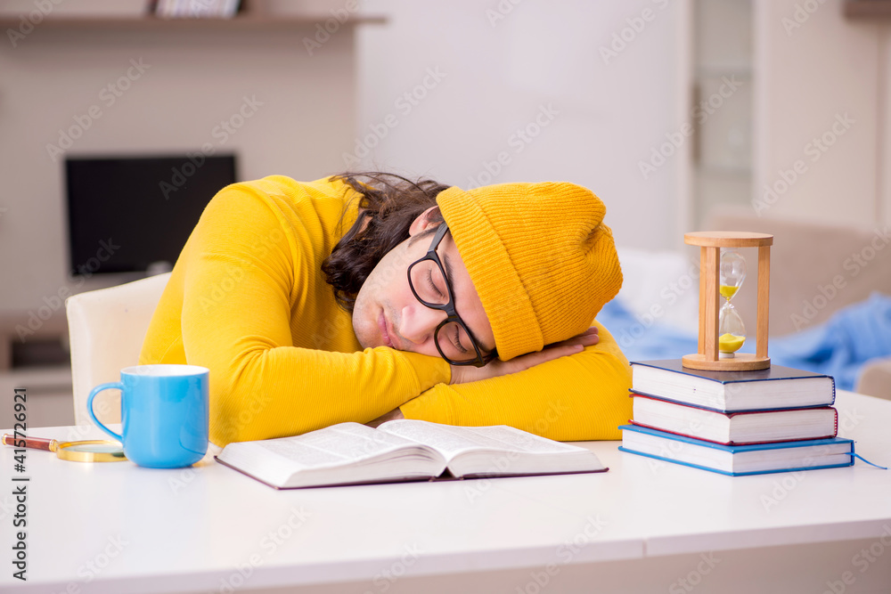 Young male student preparing for exams at home Young male student preparing for exams at home