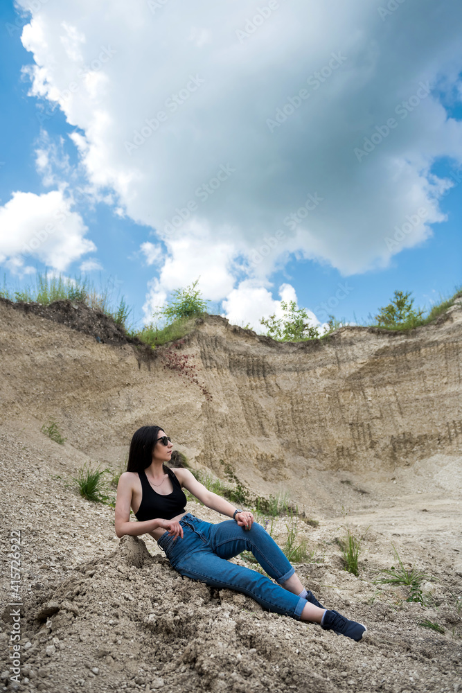 Young lady in casual cloth relax on sand rocks