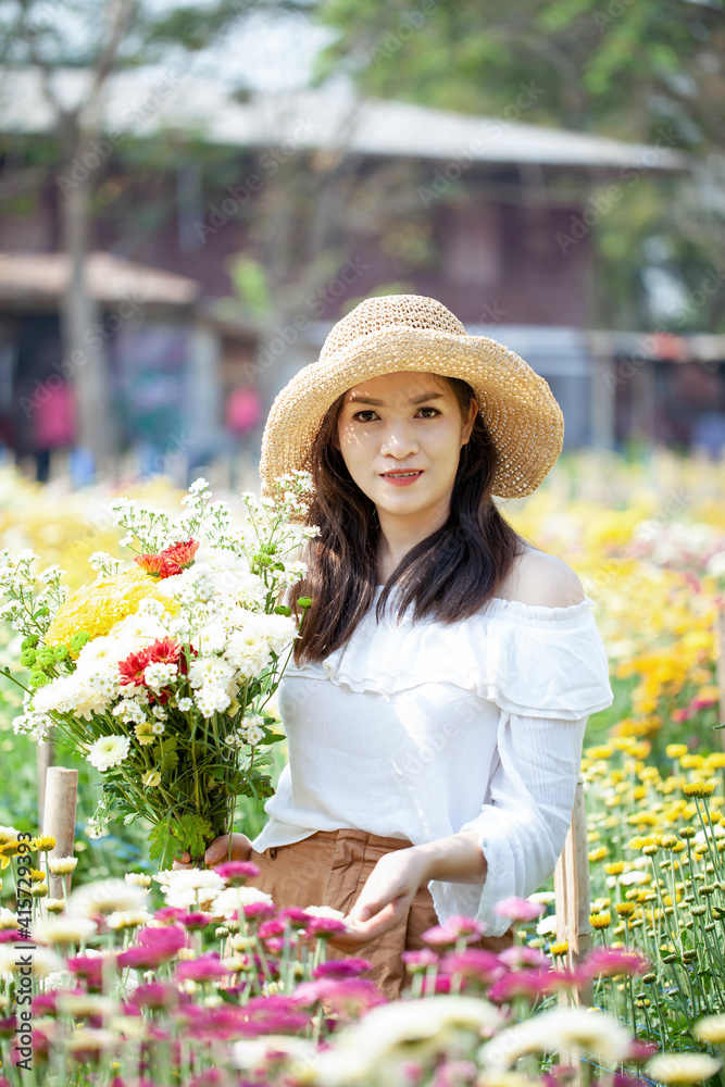 Beautiful asian woman in the flower garden