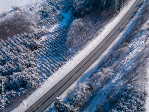 Aerial view of winter highland landscape, Forest, and road to Jihlava city, trees covered with snow and frost, Europe, Vysocina, Czech Republic © ArtushFoto