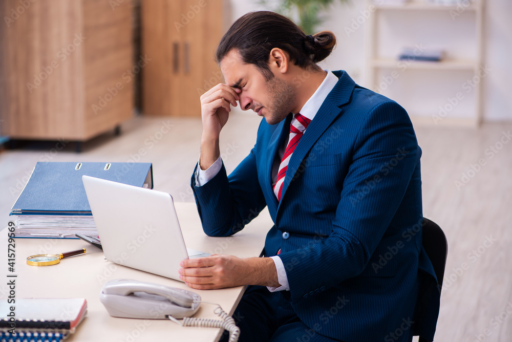 Young businessman employee sitting in the office Young businessman employee sitting in the office