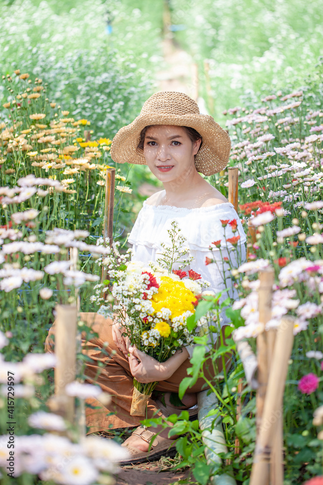 Fototapeta premium Beautiful asian woman in the flower garden