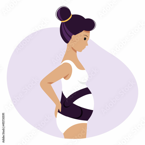 A pregnant woman with a large belly in a maternity bandage. A pregnant girl in her underwear.
