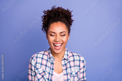 Photo of cute funny young woman wear plaid shirt empty space laughing isolated violet color background