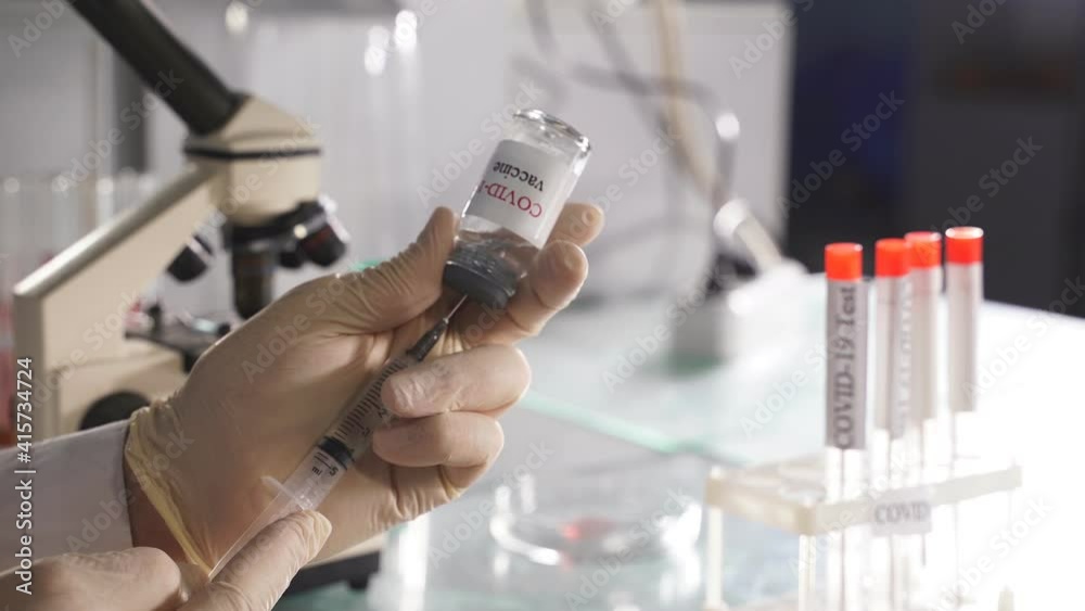 Bottle vial vaccine and syringe injection, close-up photo of hands getting liquid. Bottle vial vaccine and syringe injection, close-up photo of hands getting liquid.