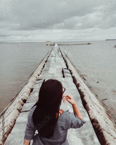 laddy on a pier photo