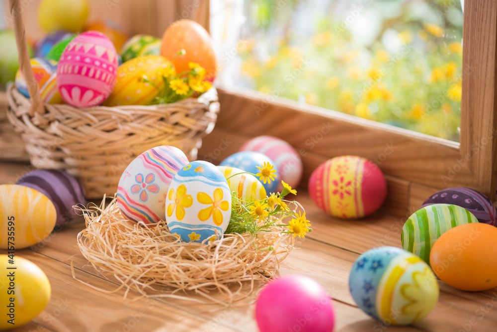 Happy Easter day colorful eggs in nest and flower on wood with window lighting Happy Easter day colorful eggs in nest and flower on wood with window lighting