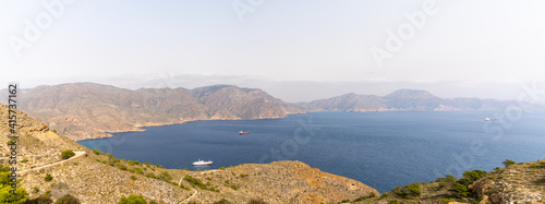 view of the Sierra de Muela mountains and the Bay of Cartagena in Murcia with moored freight ships at anchor
